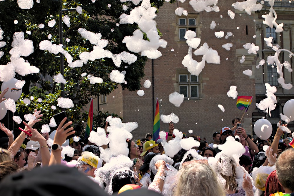 a large group of people with balloons and confetti