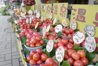 a row of baskets filled with lots of tomatoes