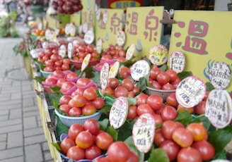 a row of baskets filled with lots of tomatoes