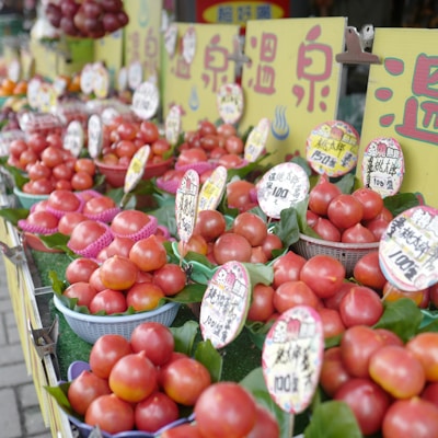 a row of baskets filled with lots of tomatoes