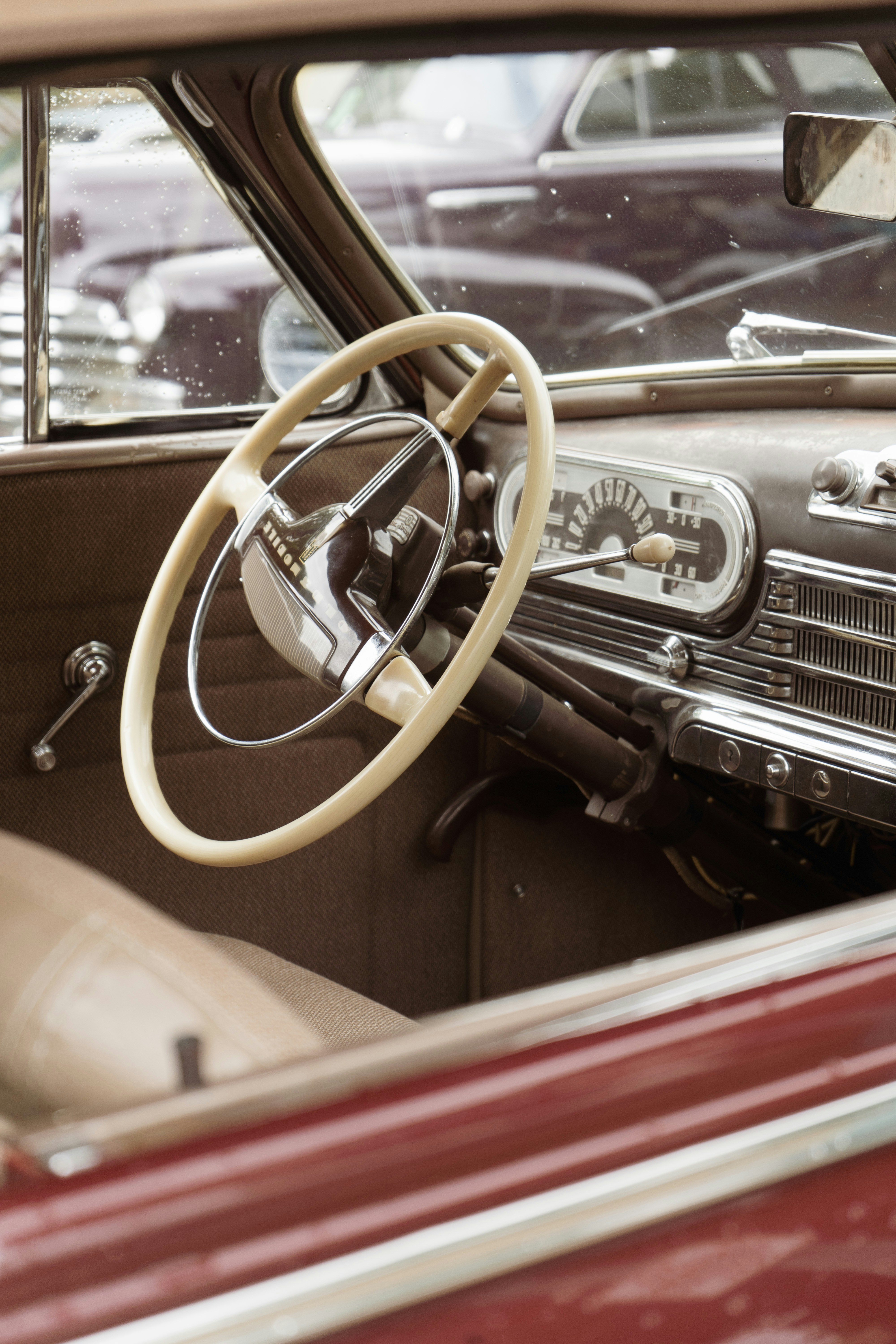 Hand installing a steering wheel accessory inside a classic Beetle interior.