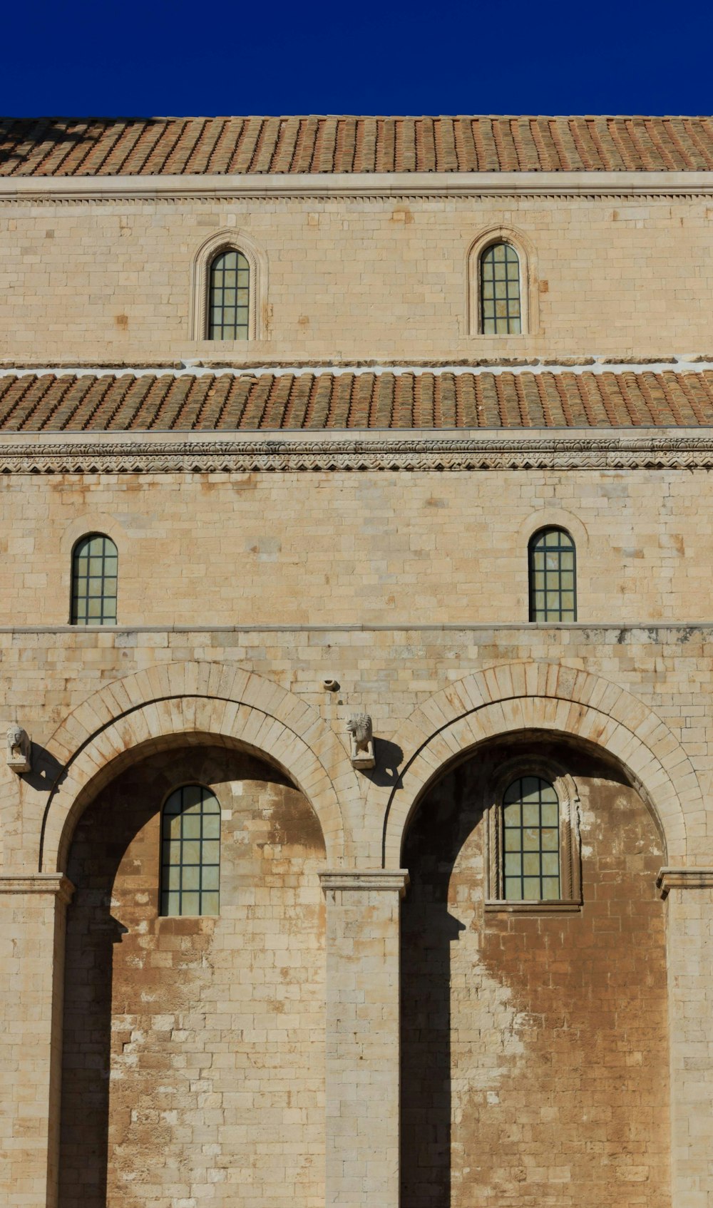 a large brick building with two arched windows