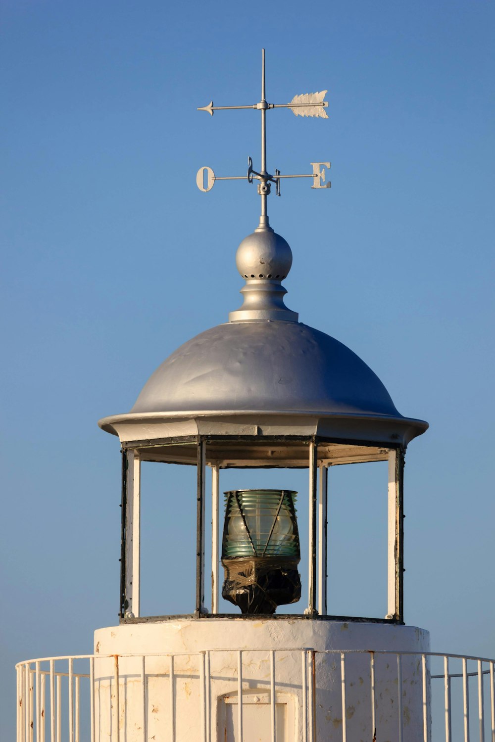 a man sitting on top of a white tower