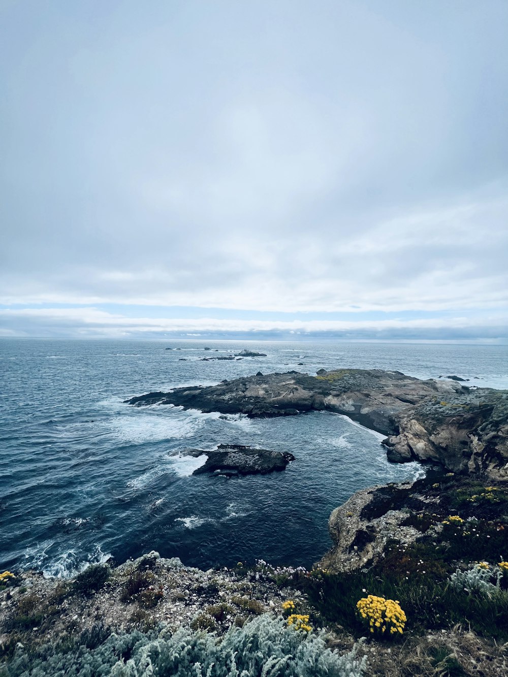 a body of water surrounded by a rocky shore