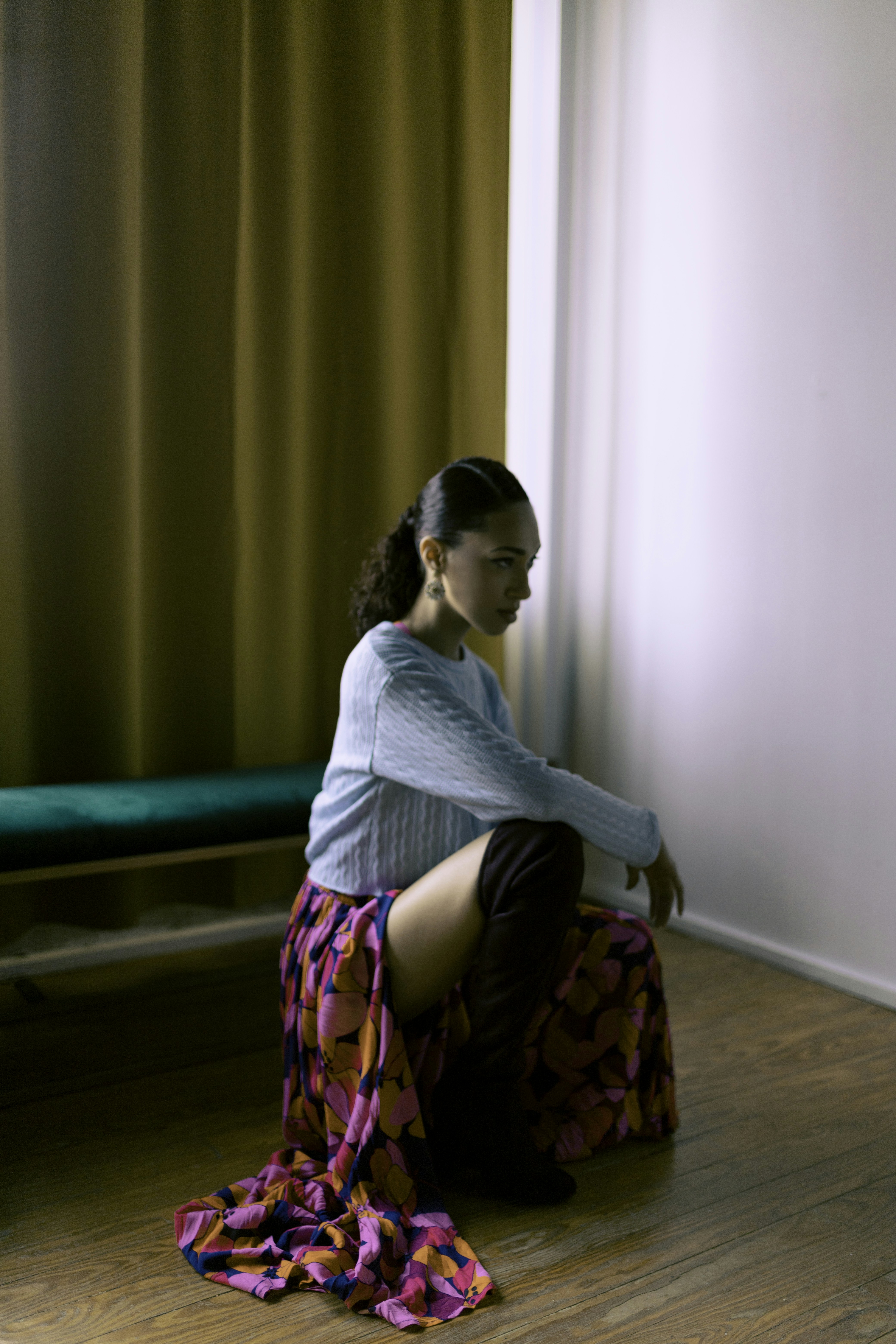 Una mujer sentada en el suelo frente a una ventana foto – Imagen de ...