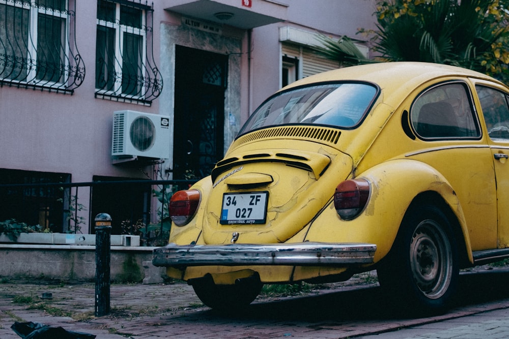 a yellow car parked on the side of the road