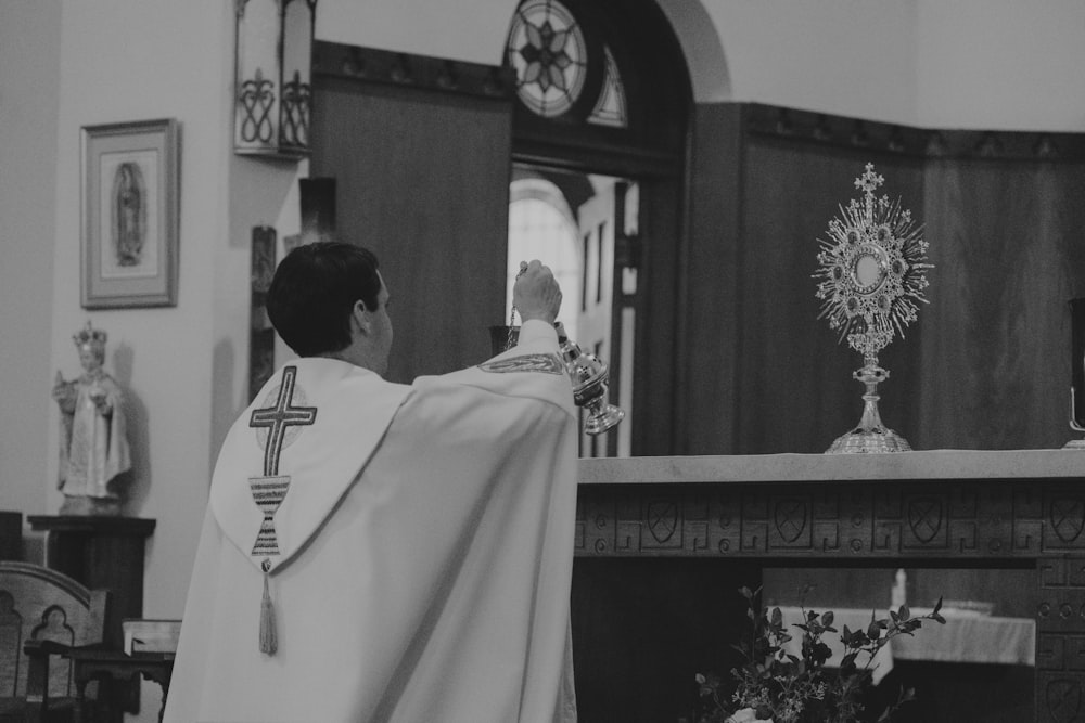 a priest standing at the alter of a church