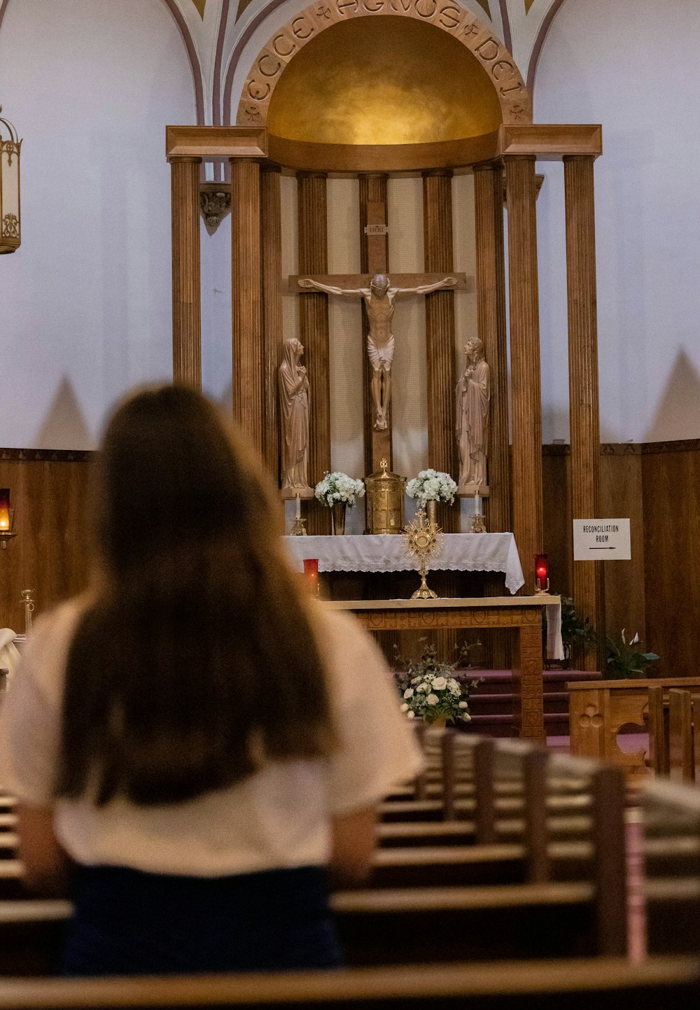 a woman standing at the alter of a church