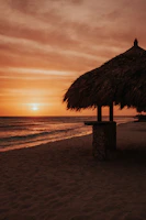 Cozy beachfront bungalow with vibrant sunset over the ocean in KwaZulu-Natal.