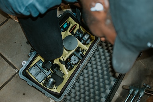 a person standing over a piece of equipment in a case