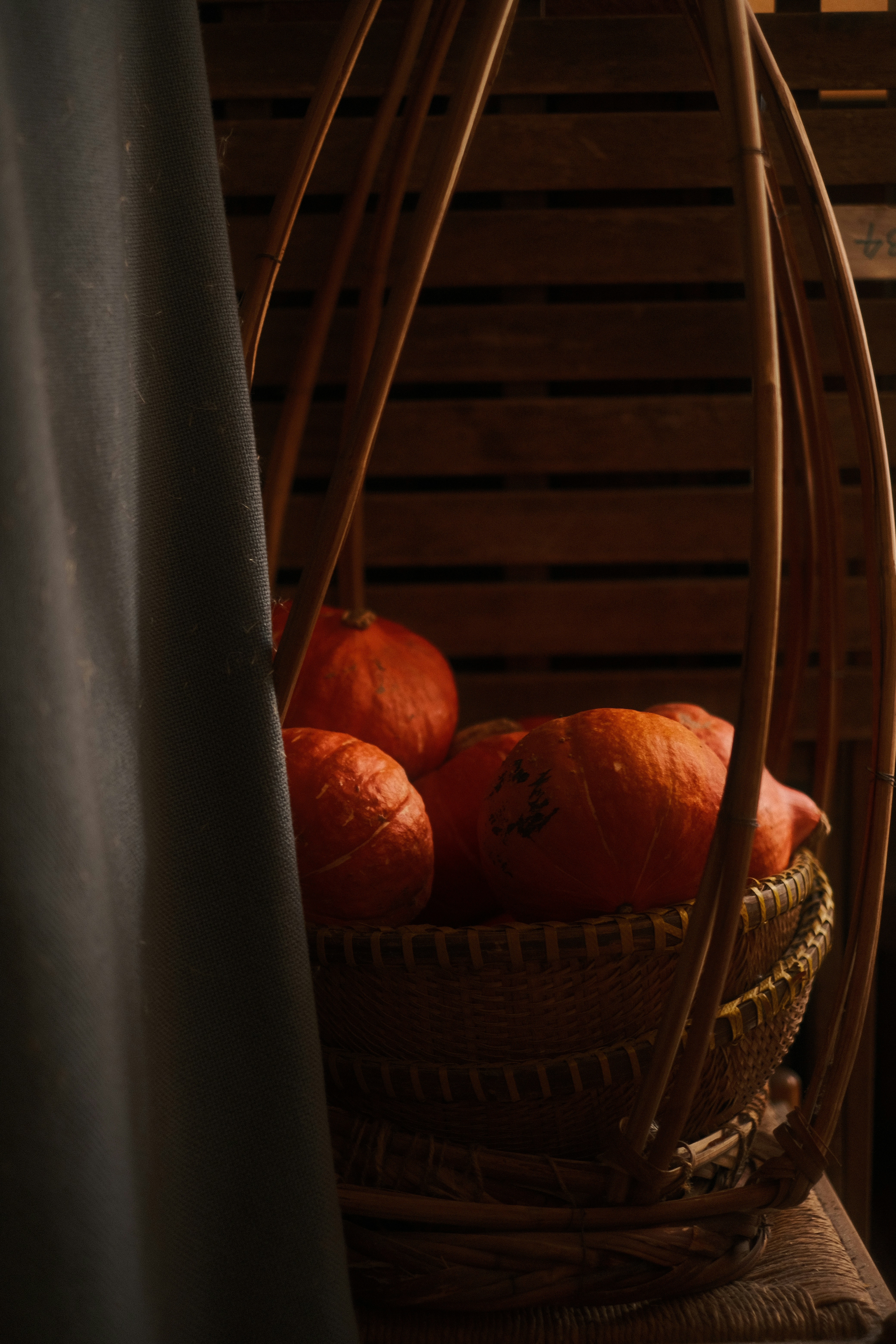 a basket filled with oranges sitting on top of a table