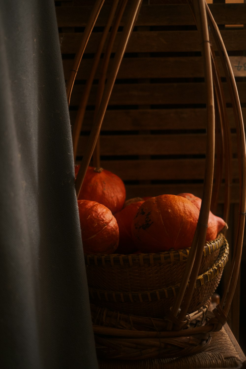 a basket filled with oranges sitting on top of a table