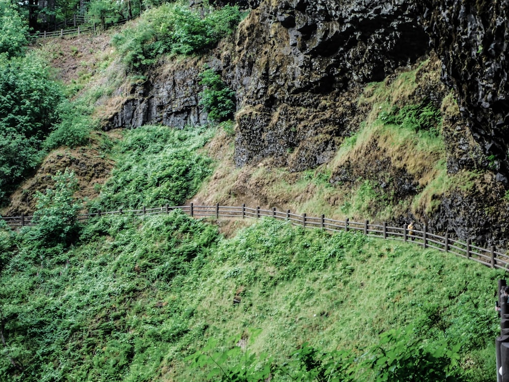 a wooden fence on the side of a mountain