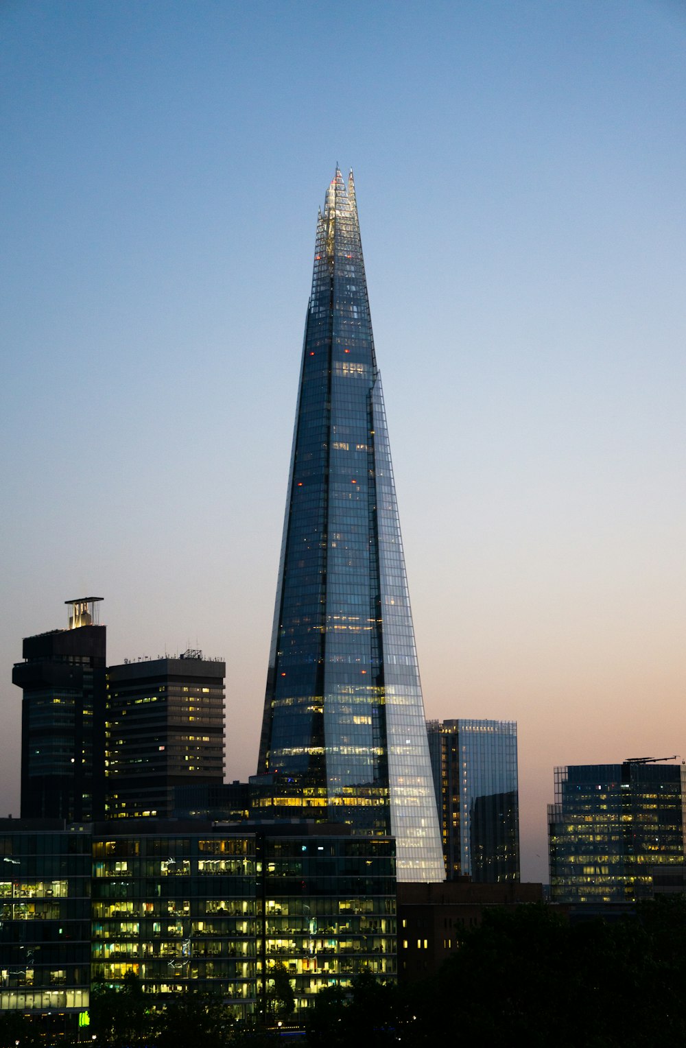 the shard of the building is lit up at night