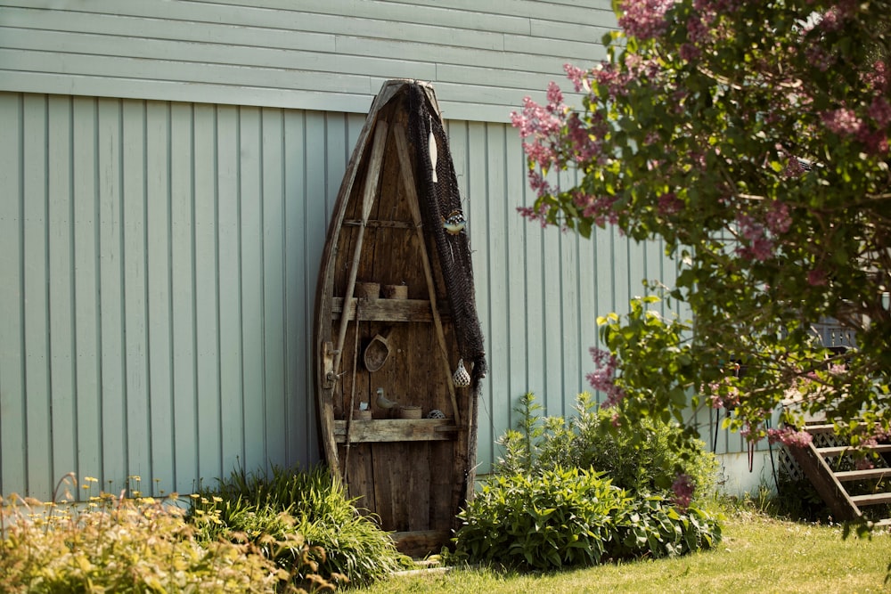 a wooden boat sitting next to a building