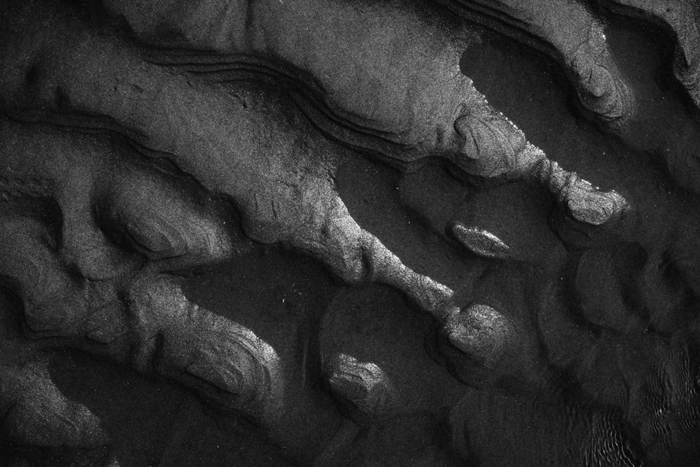 a black and white photo of rocks and water