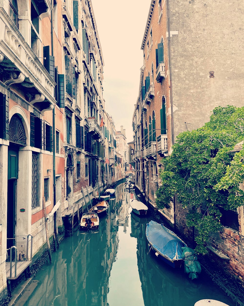 a narrow canal in a city with buildings on both sides