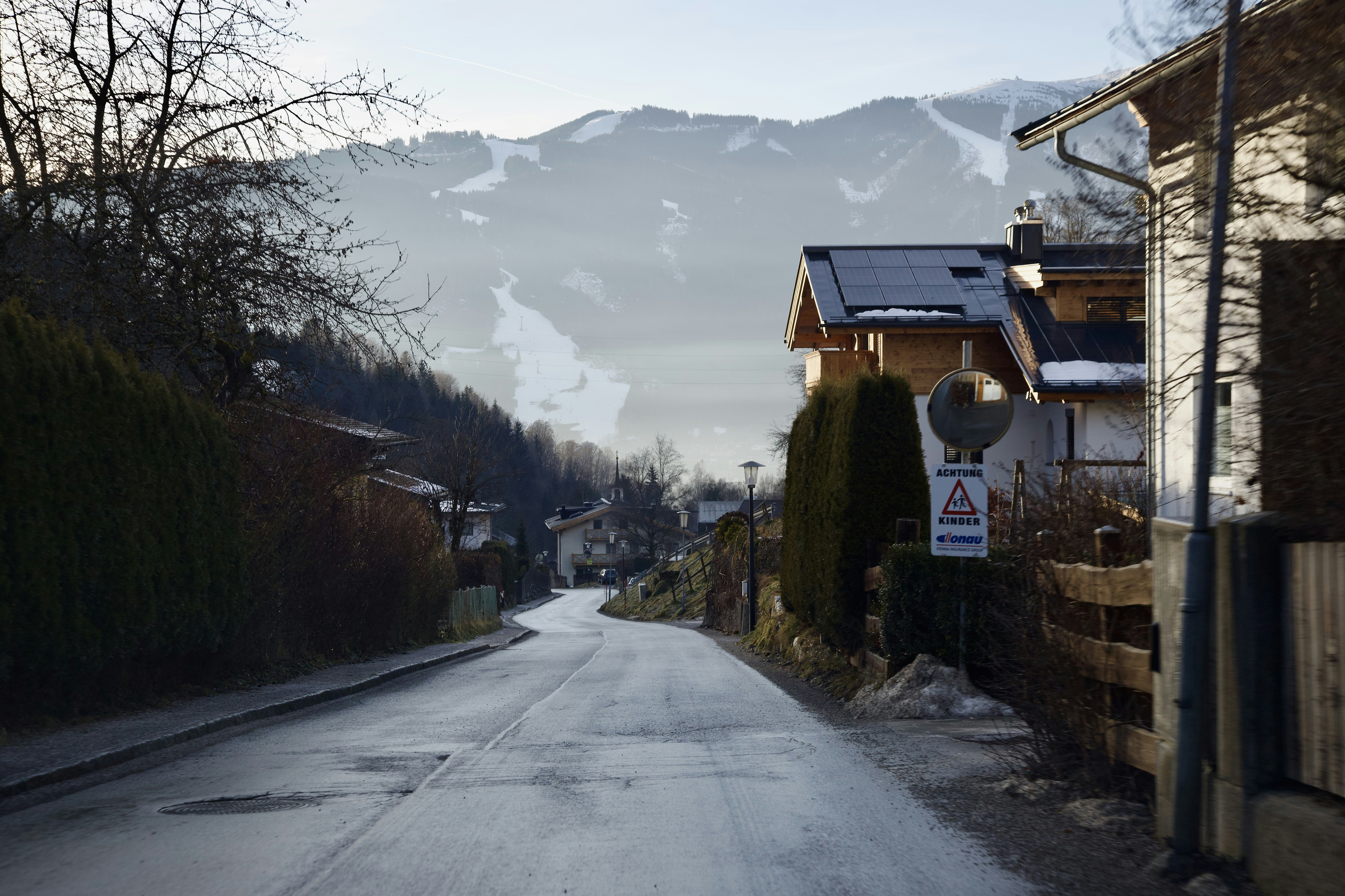 a street with a snow covered mountain in the background