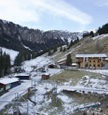 a snow covered mountain with a building on top of it