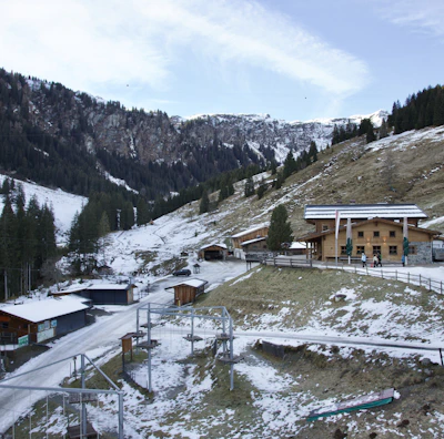 a snow covered mountain with a building on top of it