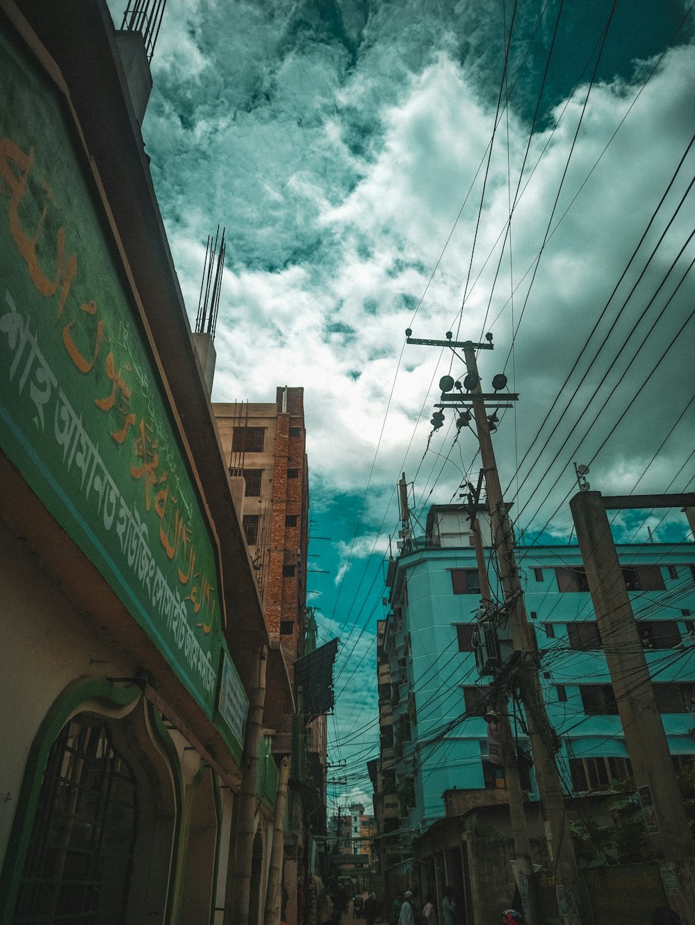 a city street with tall buildings and power lines