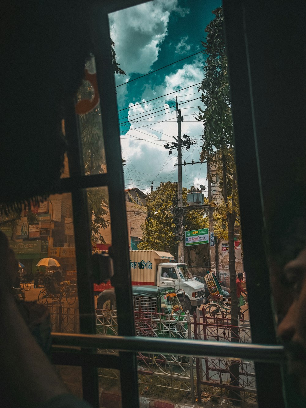 a man looking out a window at a street