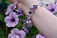Close-up of a woman's wrist adorned with a glowing purple amethyst bracelet under soft light.