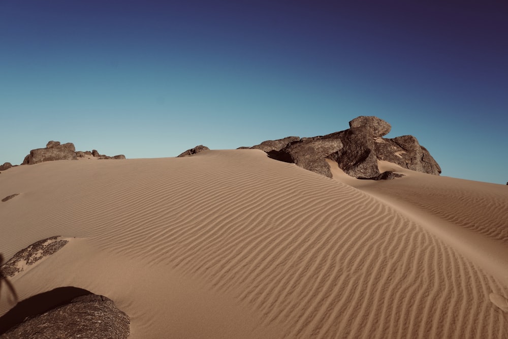 a large rock in the middle of a desert