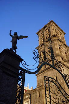 a statue of an angel on top of a gate