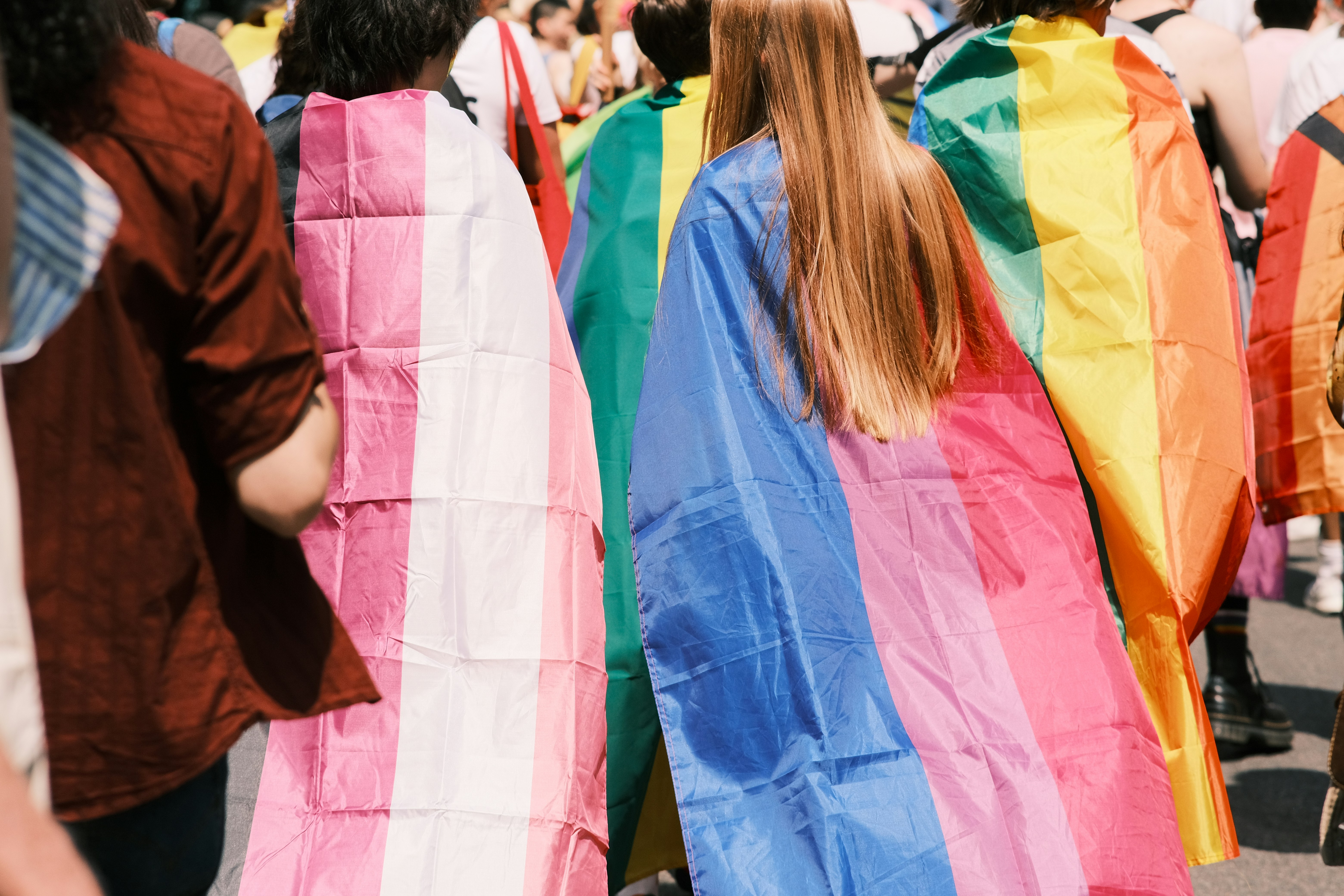 Marchers carrying rainbow flags down a Munich street during the Pride/CSD parade