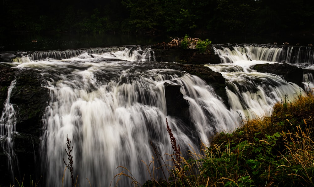 a large waterfall in the middle of a forest