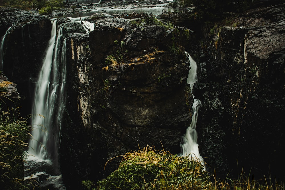 a large waterfall with water cascading down it's sides