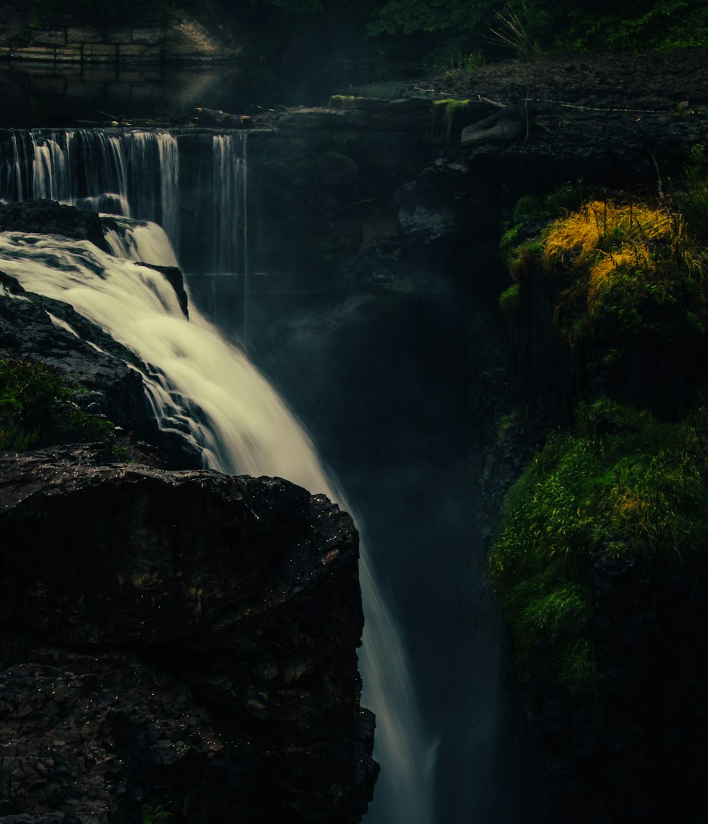 a waterfall in the middle of a lush green forest