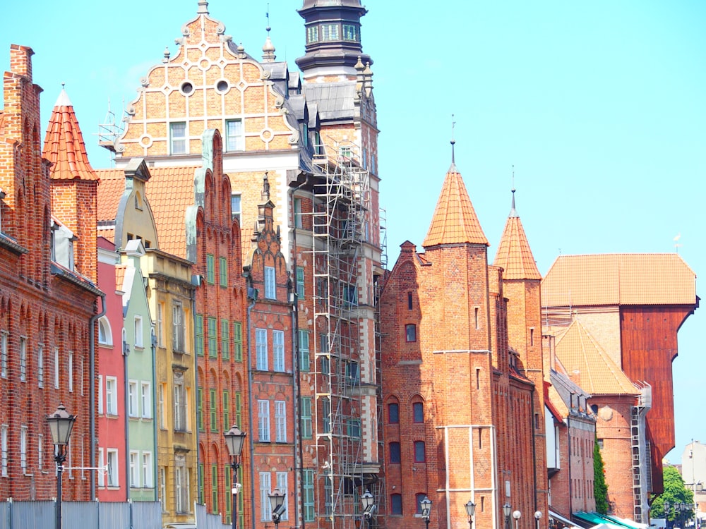 a row of old brick buildings with scaffolding on them