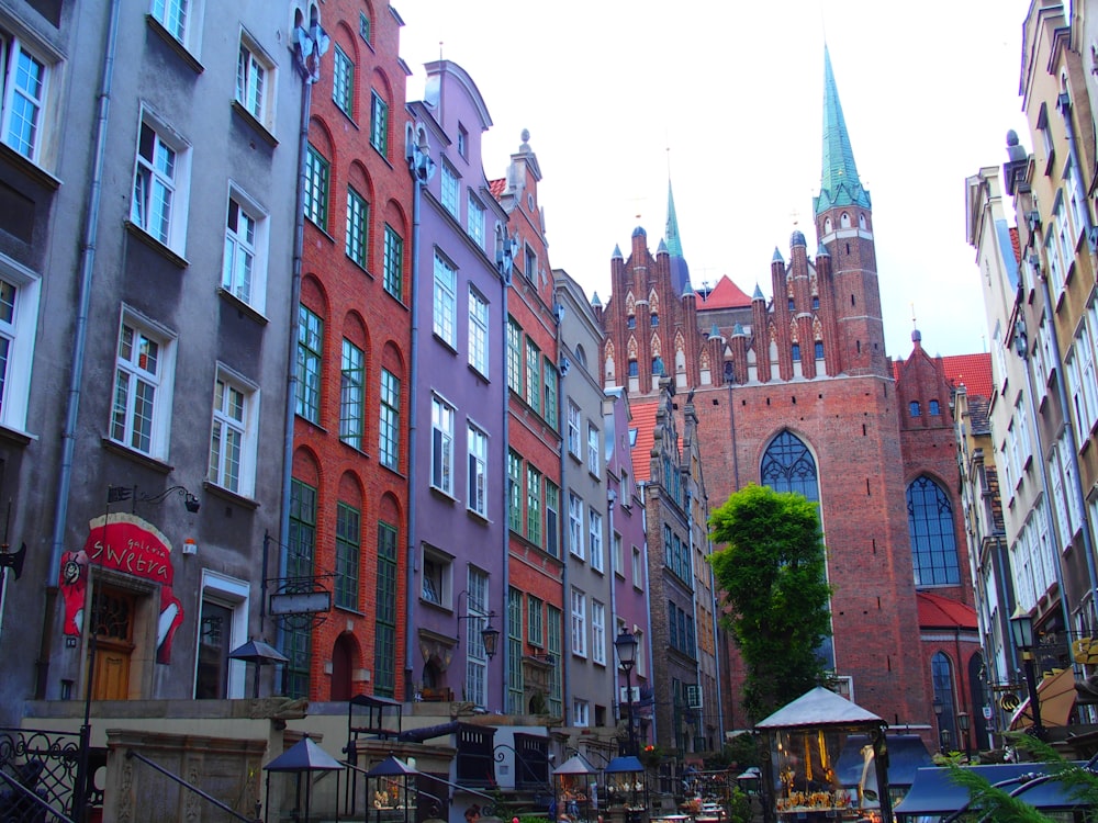 a row of buildings in a city with a clock tower