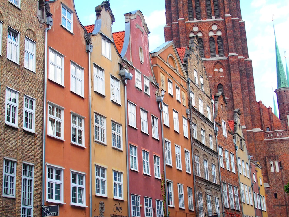 a row of buildings with a clock tower in the background