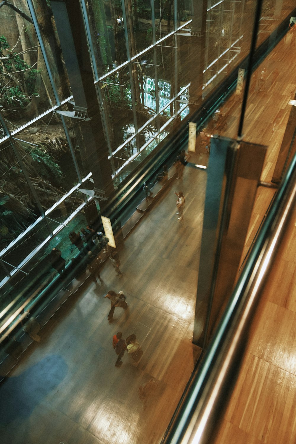 a group of people walking down a wooden floor