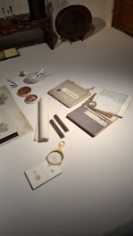 A collection of beautifully crafted calligraphy tools and colorful inks on a wooden desk.