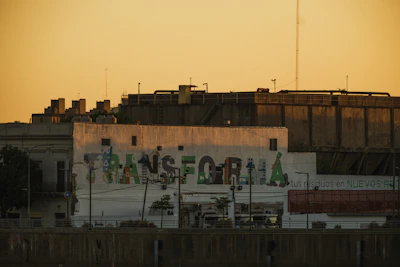 A vibrant urban street scene at golden hour with dynamic shadows and colorful graffiti walls.