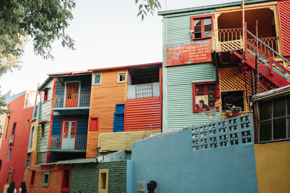 a row of multicolored buildings with a fire escape