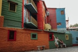 A joyful traveler posing near the colorful Bo-Kaap houses