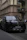 Luxury black car parked outside a downtown Chicago office building