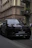 Luxury black car parked outside a downtown Chicago office building