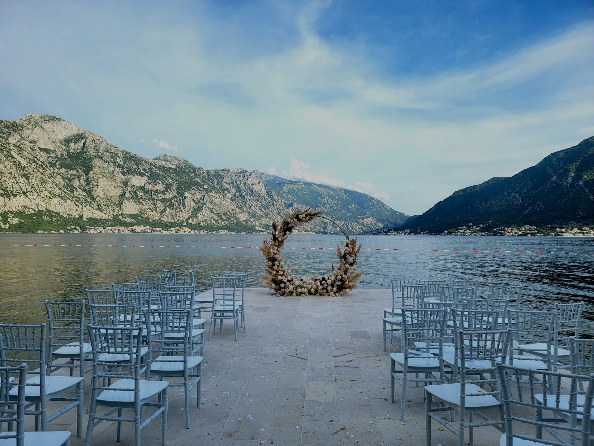 a bunch of chairs that are by a body of water