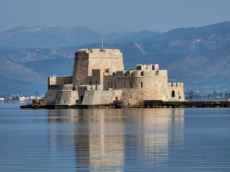 The island castle of Bourtzi reflected in still water