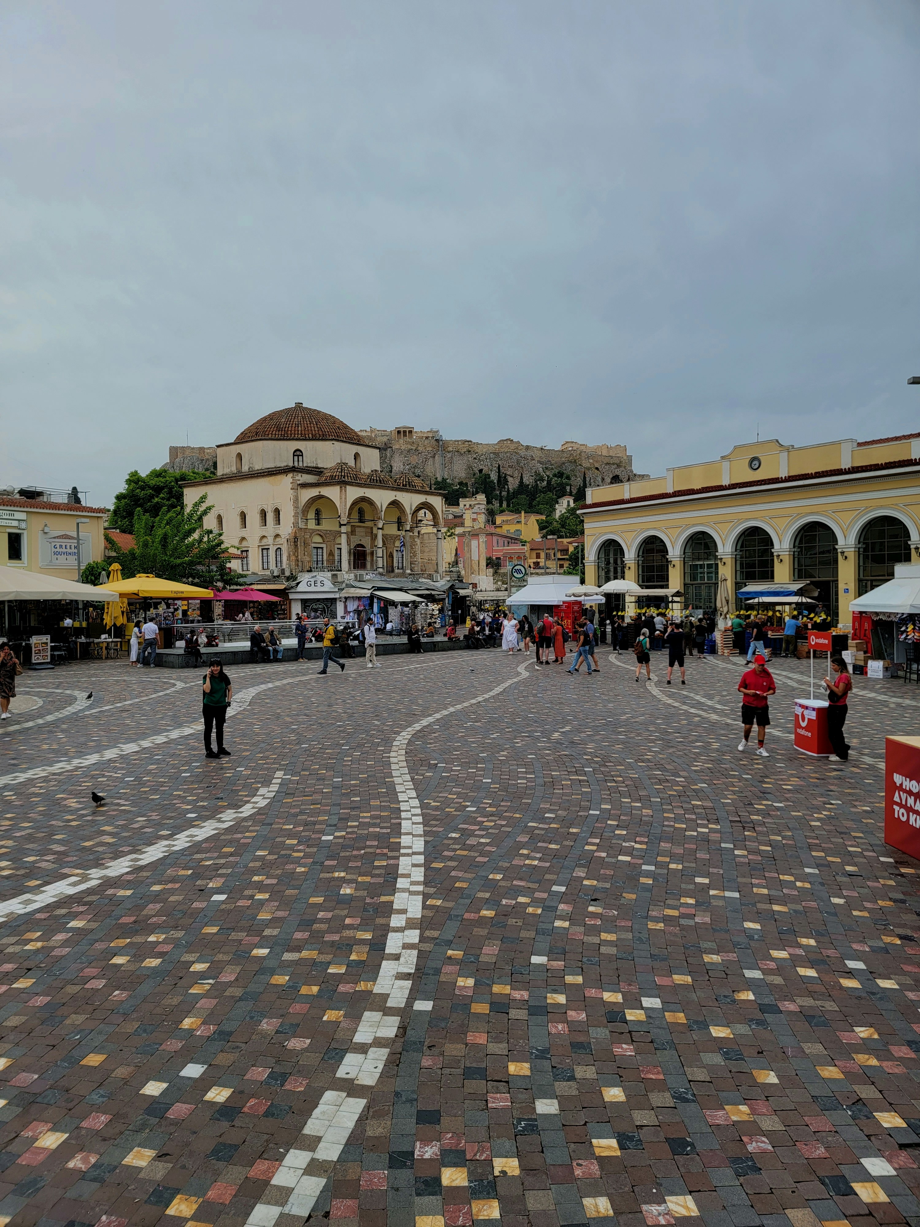 A lively Roman piazza bustling with locals and tourists enjoying the afternoon.