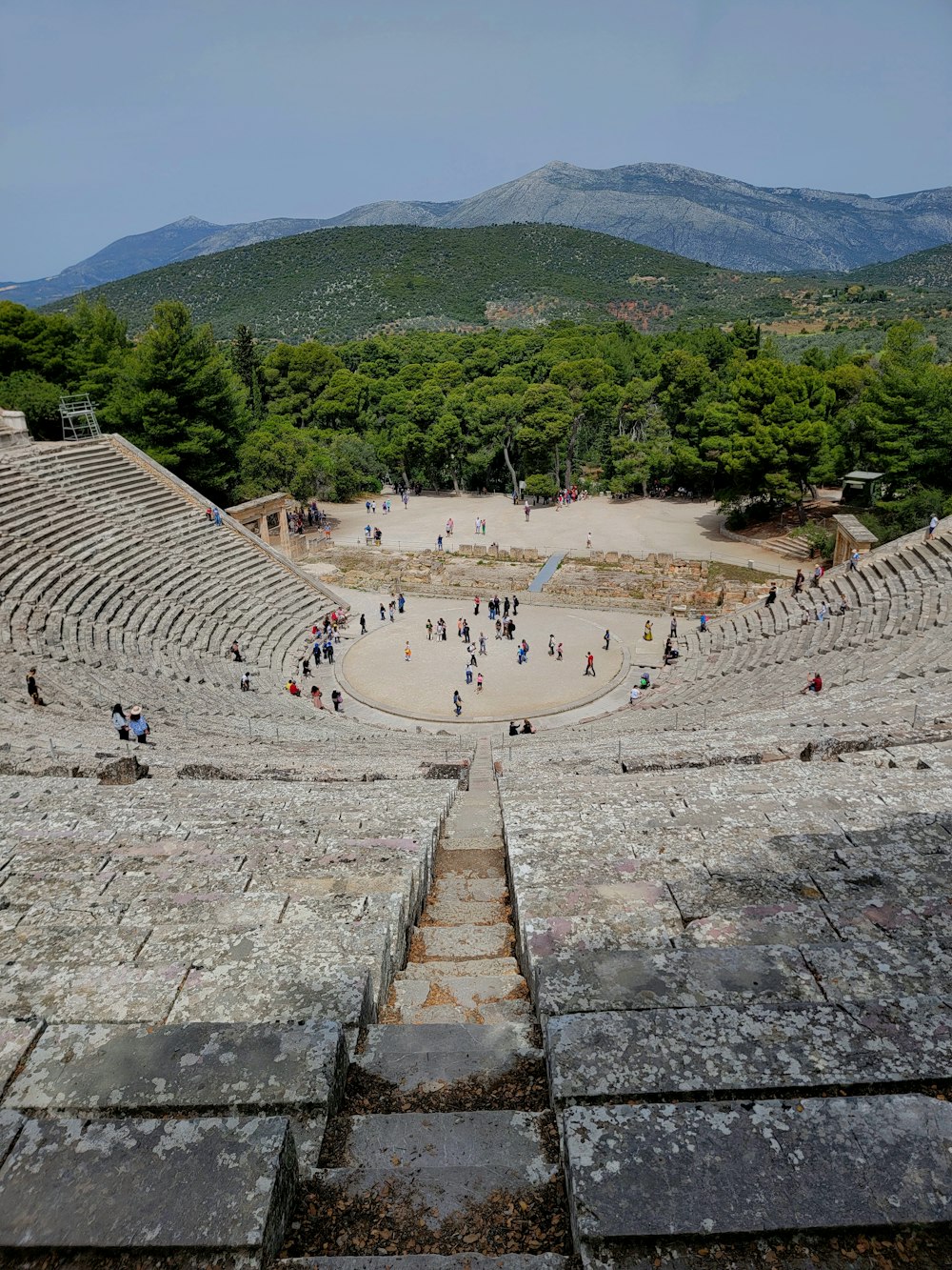 a view of a roman ampule with people walking around it