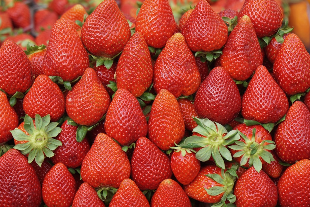 a pile of red strawberries sitting on top of each other