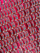 Colorful Thai snack packages arranged neatly on a display shelf.
