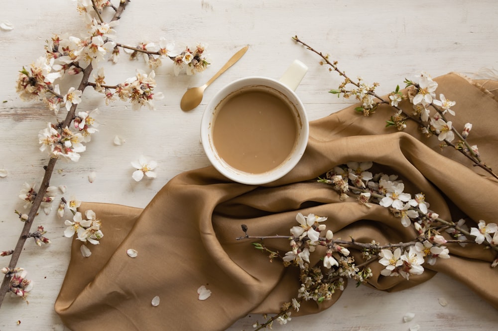 a cup of coffee sits on top of a table